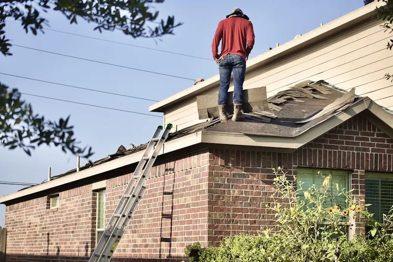 Professional roofer working on a residential roof in Belair Woods